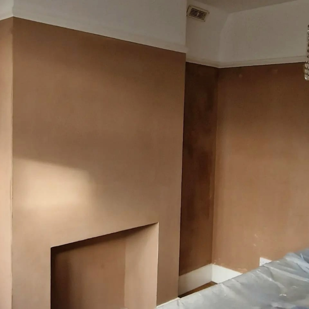 Freshly skimmed walls in room including fireplace and alcoves